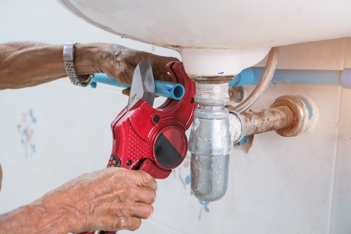 Plumber Repairing cuting pvc pipe for fix broken Water faucet for maintenance